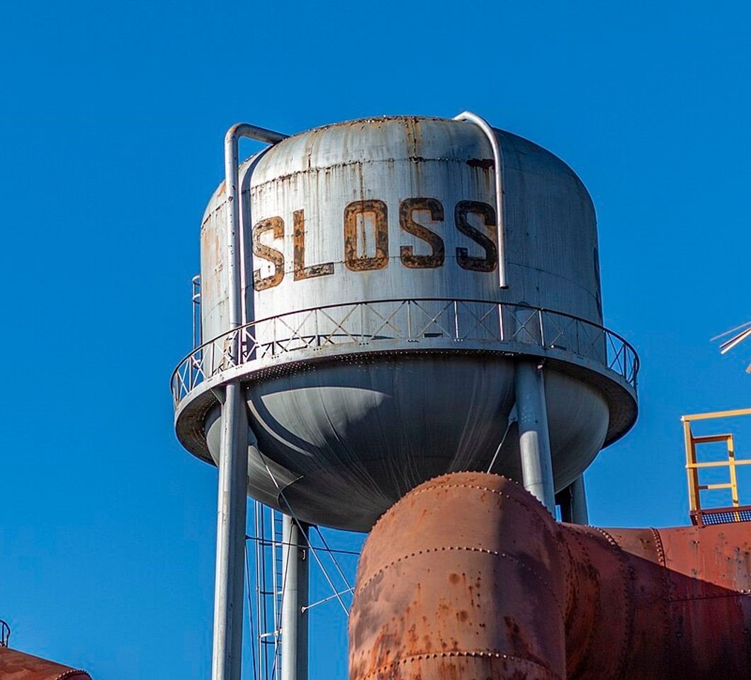 The Sloss water tower standing over rusted blast furnace vessels in Birmingham, Alabama